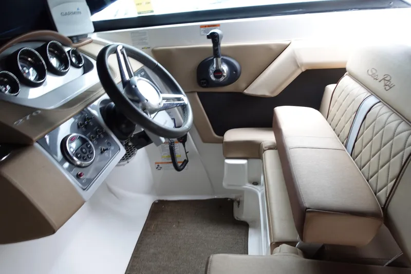 Slide: The Image of 2015 Sea Ray 270 Sundeck Outboard helm with steering wheel and controls. - 5