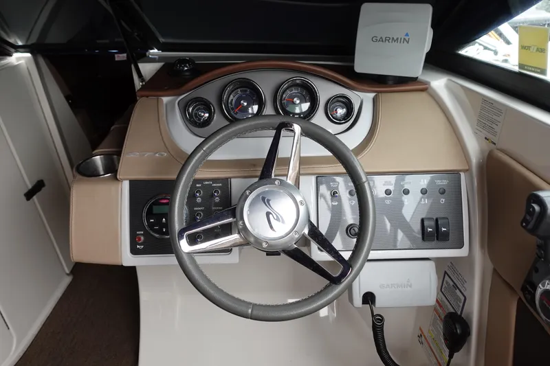 Slide: The Image of 2015 Sea Ray 270 Sundeck Outboard dashboard with Garmin navigation system and steering wheel. - 6