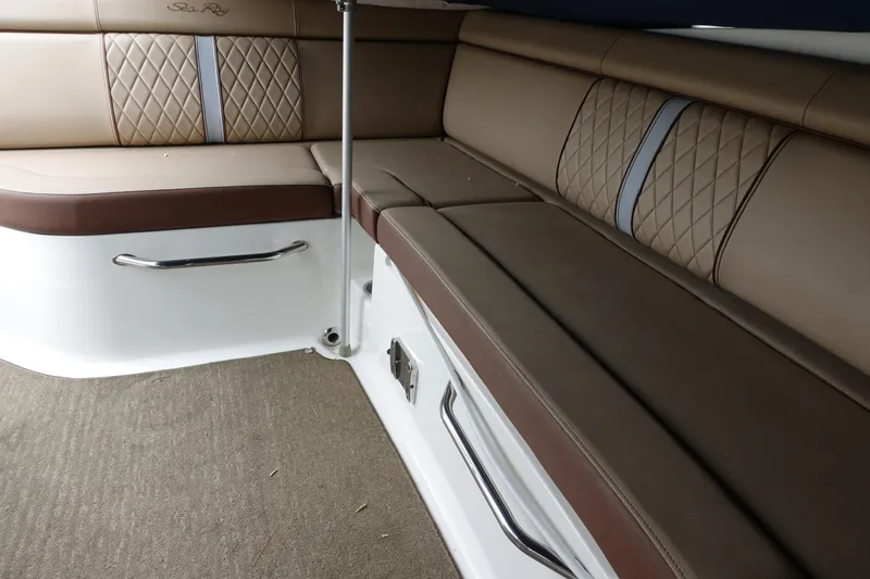 Slide: The Image of 2015 Sea Ray 270 Sundeck Outboard interior with brown leather seating and quilted accents. - 7