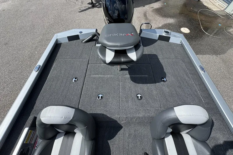 Slide: The Image of 2026 Vexus AVX1880 boat interior with gray seating and carpeted deck. - 13