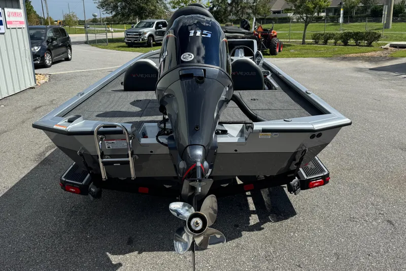 Slide: The Image of 2026 Vexus AVX1880 boat with Yamaha 115 outboard motor, parked outdoors. - 16