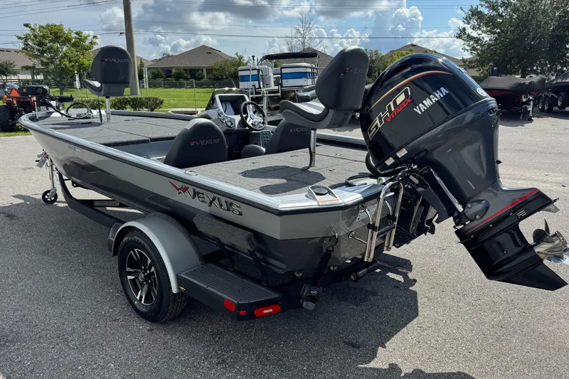 Slide: The Image of 2026 Vexus AVX1880 boat with Yamaha engine, parked outdoors on a sunny day. - 17