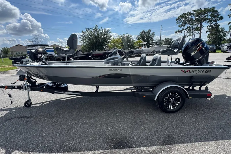 Slide: The Image of 2026 Vexus AVX1880 boat on trailer, parked outdoors under a partly cloudy sky. - 3