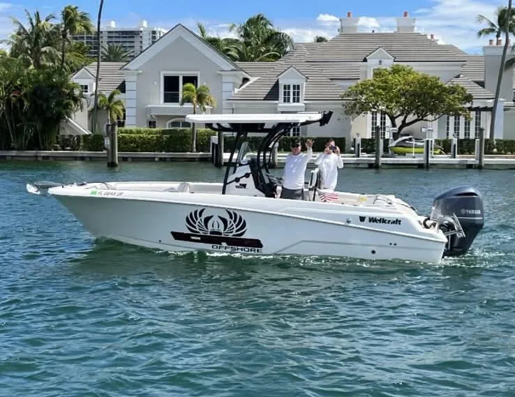 The Image of 2019 Wellcraft 242 Scarab Offshore boat cruising near waterfront homes. - 1