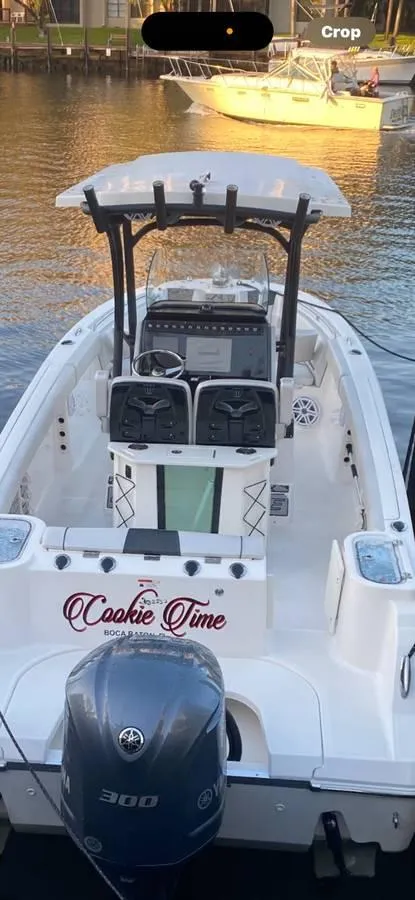Slide: The Image of 2019 Wellcraft 242 Scarab Offshore boat docked, featuring "Cookie Time" name on the stern. - 3