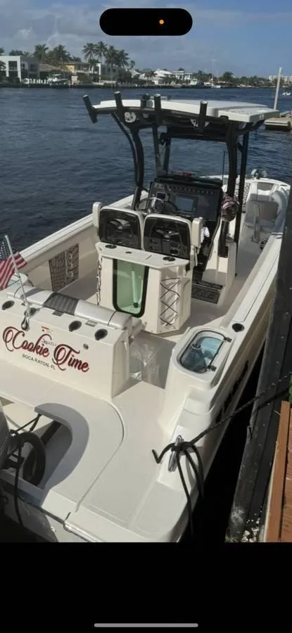 Slide: The Image of 2019 Wellcraft 242 Scarab Offshore boat docked by the water. - 5