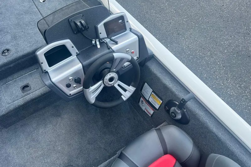 Slide: The Image of 2025 Tracker Pro Team 190 boat cockpit with steering wheel and controls. - 5