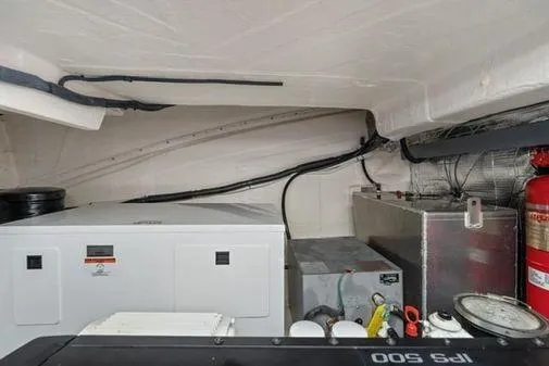 Slide: The Image of Engine room of 2017 Regal 42 Grande Coupe with visible equipment and fire extinguisher. - 23