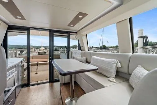 Slide: The Image of Luxurious interior of 2017 Regal 42 Grande Coupe yacht with elegant seating and dining area. - 9