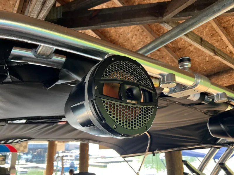 Slide: The Image of Klipsch speaker mounted on a 2025 MasterCraft NXT23 boat under a wooden roof. - 11