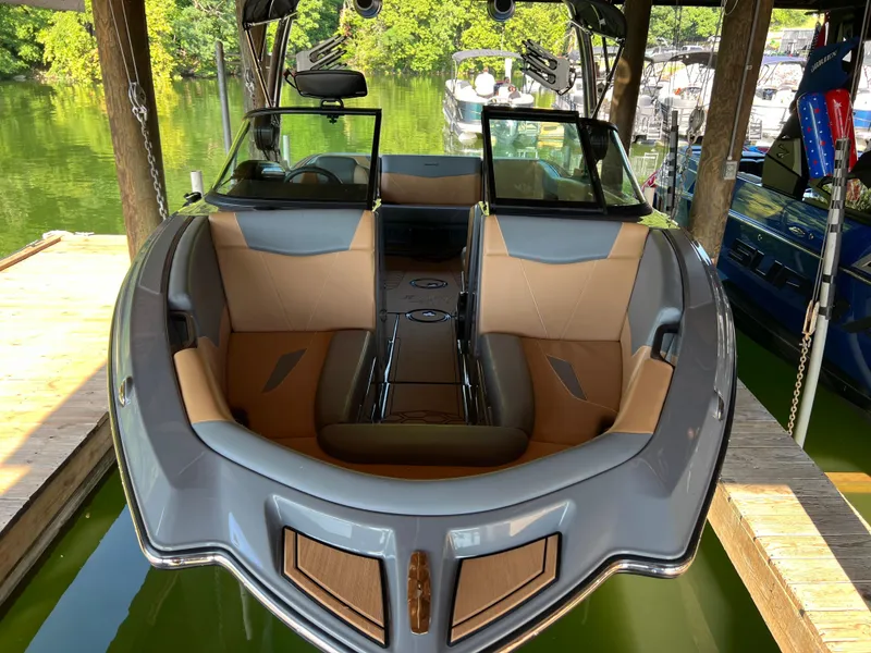 Slide: The Image of 2025 MasterCraft NXT23 boat interior at dock, featuring sleek design and comfortable seating. - 5