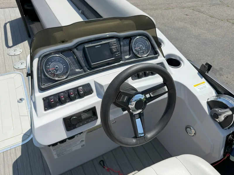 Slide: The Image of 2022 Godfrey Sweetwater 2186 C boat dashboard with steering wheel and control panel. - 10