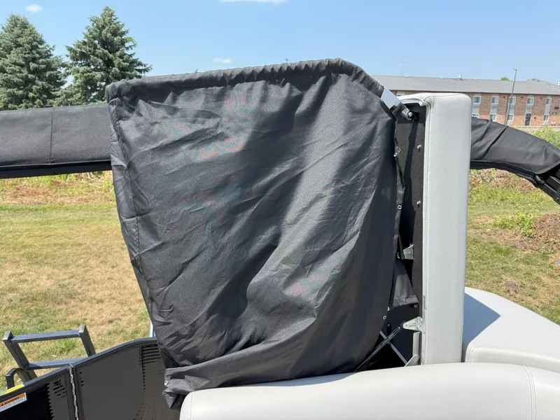 Slide: The Image of 2022 Godfrey Sweetwater 2186 C boat with black fabric cover, outdoor setting. - 14