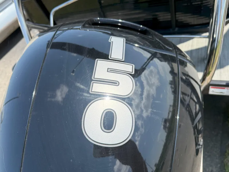 Slide: The Image of Close-up of a 150 HP outboard motor on a 2022 Godfrey Sweetwater 2186 C boat. - 16