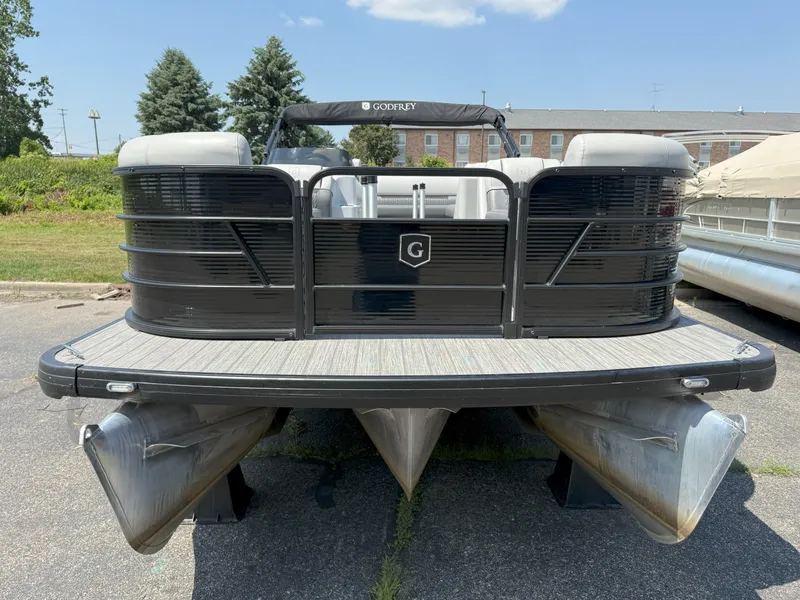 Slide: The Image of 2022 Godfrey Sweetwater 2186 C pontoon boat, black exterior, parked outdoors. - 2