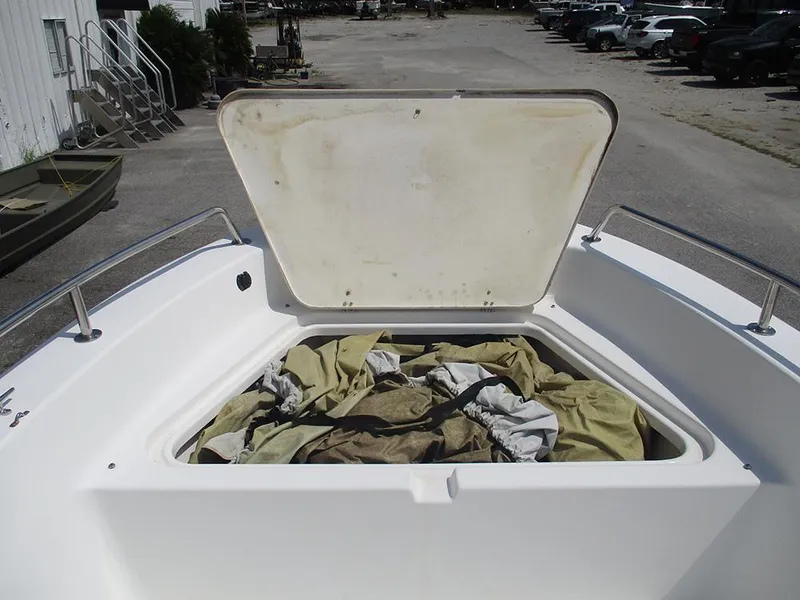 Slide: The Image of Open storage compartment on 2004 Sea Pro 180 Center Console boat, containing tarps. - 14