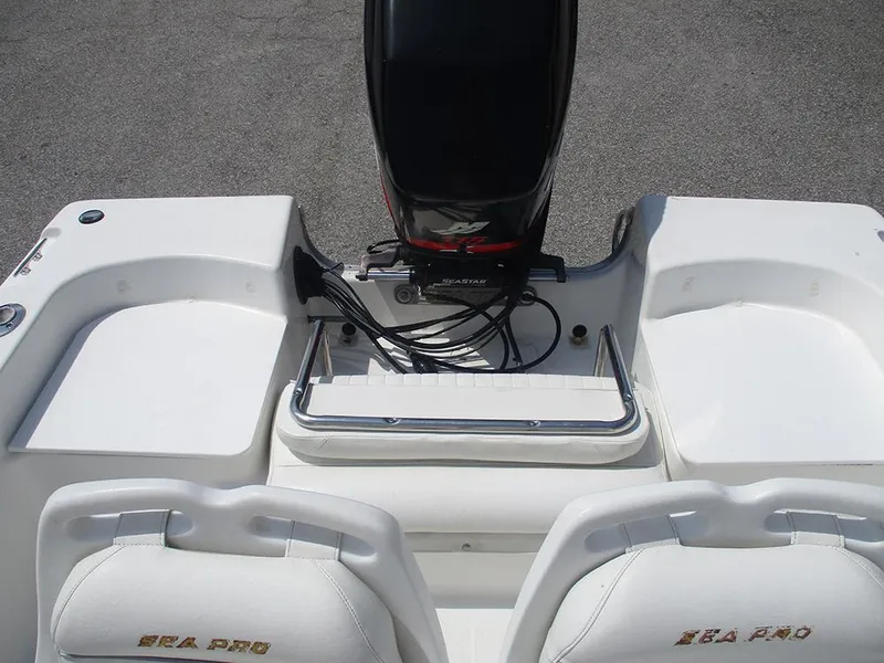 Slide: The Image of 2004 Sea Pro 180 Center Console boat interior with engine and seating. - 16