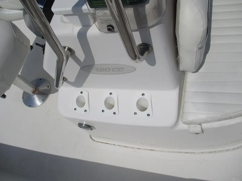Slide: The Image of 2004 Sea Pro 180 Center Console boat interior with white seating and rod holders. - 22