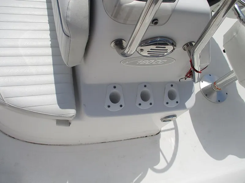 Slide: The Image of 2004 Sea Pro 180 Center Console boat interior with rod holders and seating. - 23