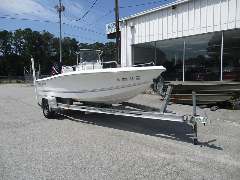 Slide: The Image of 2004 Sea Pro 180 Center Console boat on trailer outside a marine center. - 5