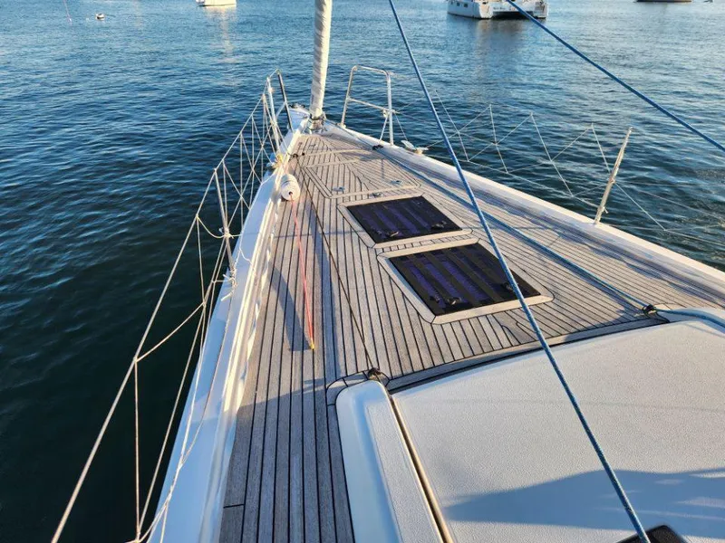 Slide: The Image of 2018 X-Yachts X4.9 sailboat deck with teak finish, anchored in calm waters. - 12