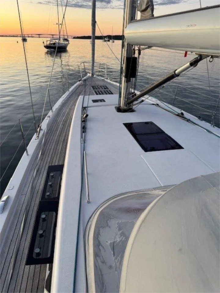 Slide: The Image of 2018 X-Yachts X4.9 sailboat deck at sunset, calm waters, elegant design. - 15