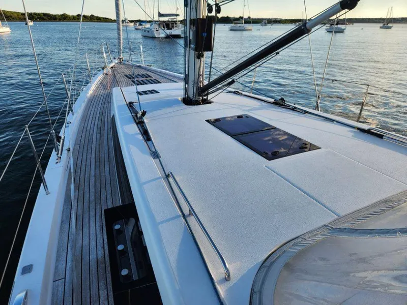 Slide: The Image of 2018 X-Yachts X4.9 sailboat deck with sleek design, docked in a serene marina. - 17