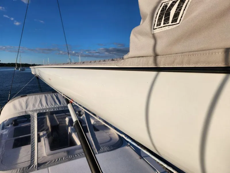 Slide: The Image of 2018 X-Yachts X4.9 sailboat deck with boom, under clear blue sky. - 18