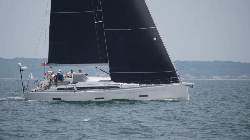 Slide: The Image of 2018 X-Yachts X4.9 sailing on open water with black sails. - 2