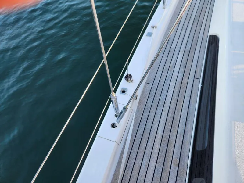 Slide: The Image of Deck view of 2018 X-Yachts X4.9 sailboat with teak flooring and ocean backdrop. - 21