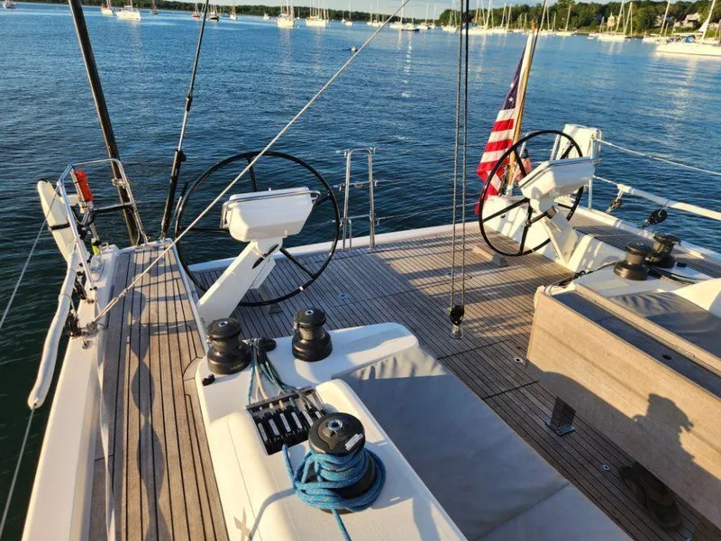 Slide: The Image of 2018 X-Yachts X4.9 sailboat deck with dual steering wheels and American flag. - 22
