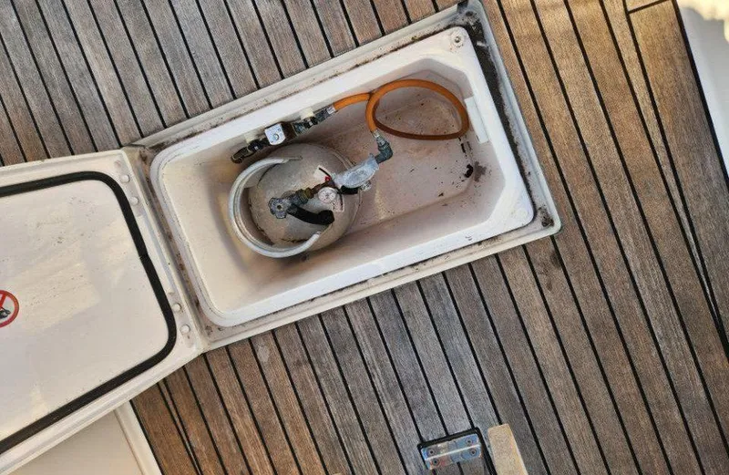 Slide: The Image of Open storage compartment on 2018 X-Yachts X4.9, revealing gas cylinder and connections. - 31