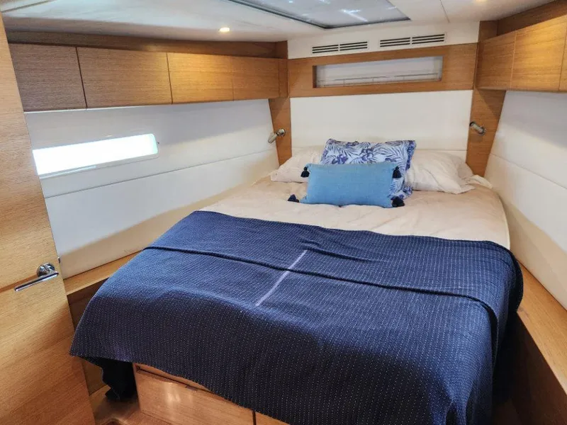 Slide: The Image of Luxurious cabin interior of 2018 X-Yachts X4.9 with cozy bedding and wooden accents. - 33