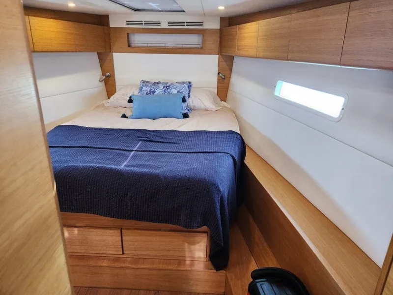 Slide: The Image of Luxurious cabin interior of 2018 X-Yachts X4.9 with cozy bedding and wooden accents. - 35