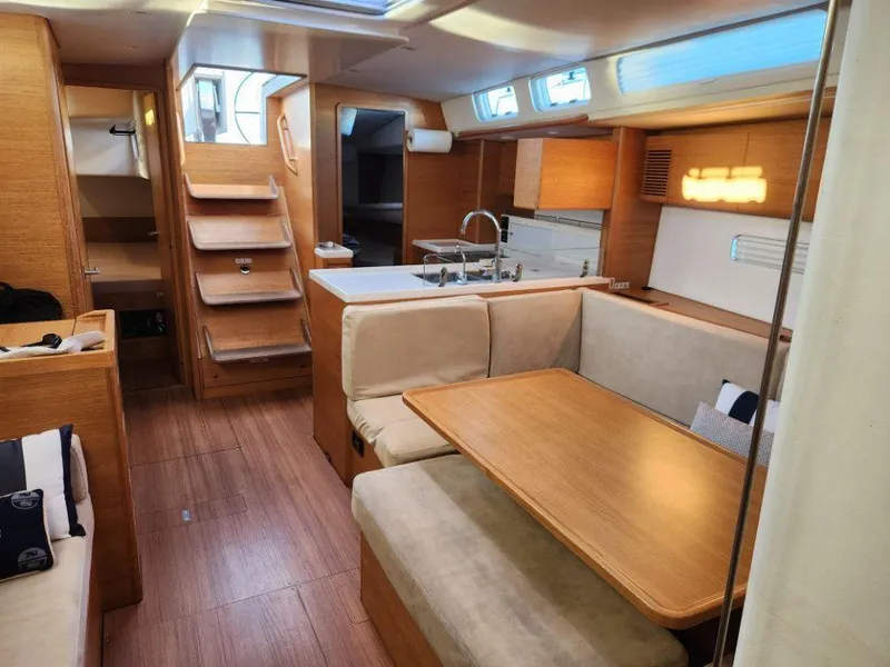 Slide: The Image of Interior of 2018 X-Yachts X4.9 sailboat with wooden finishes and cozy seating area. - 41