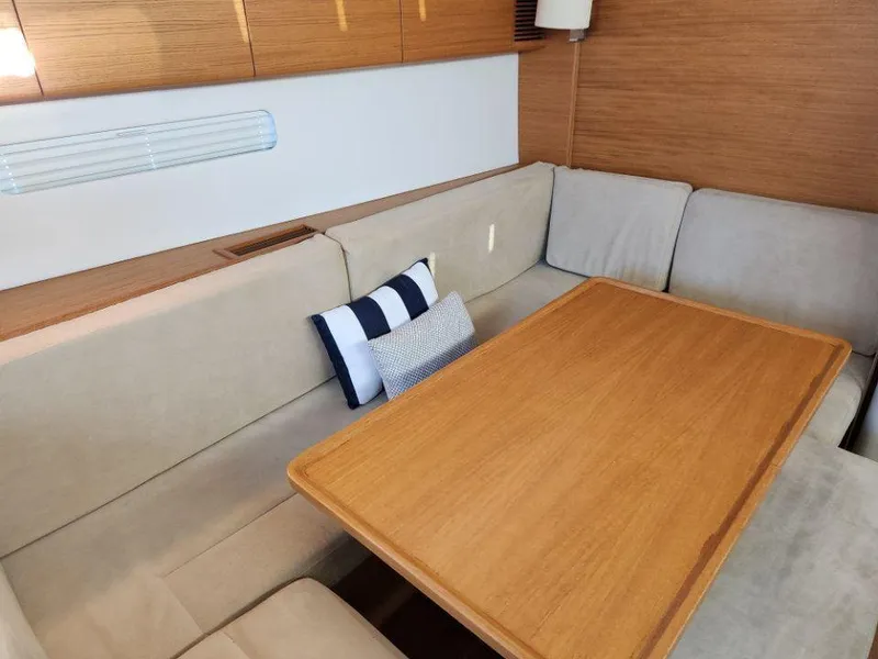Slide: The Image of Interior of 2018 X-Yachts X4.9 with wooden table and beige seating. - 43