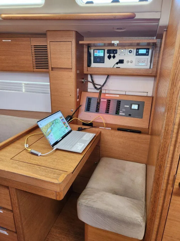 Slide: The Image of Navigation station in 2018 X-Yachts X4.9 sailboat with laptop and control panel. - 48