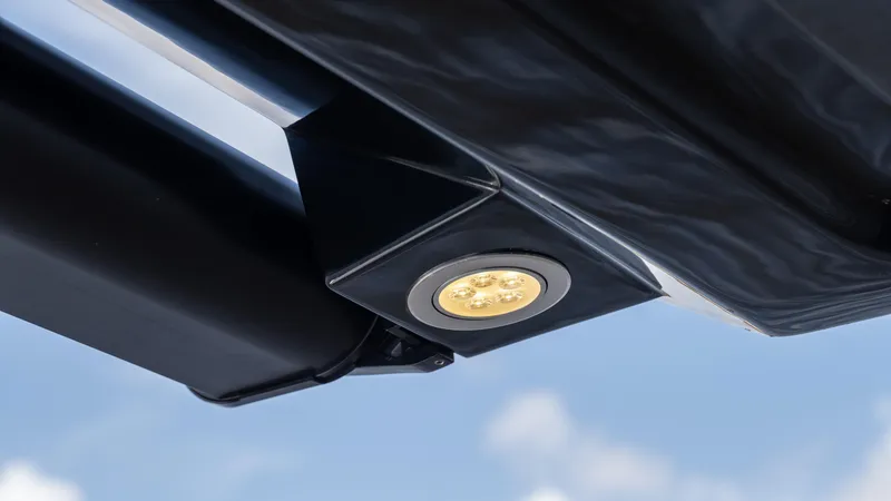 Slide: The Image of Close-up of Hanover 387 Outboard 2025 LED light fixture against blue sky. - 13