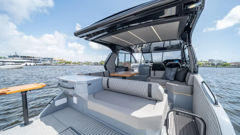 Slide: The Image of Luxurious 2025 Hanover 387 Outboard boat with spacious seating and modern design on the water. - 15