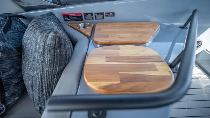 Slide: The Image of Interior of 2025 Hanover 387 Outboard with wooden table and cushioned seating. - 17