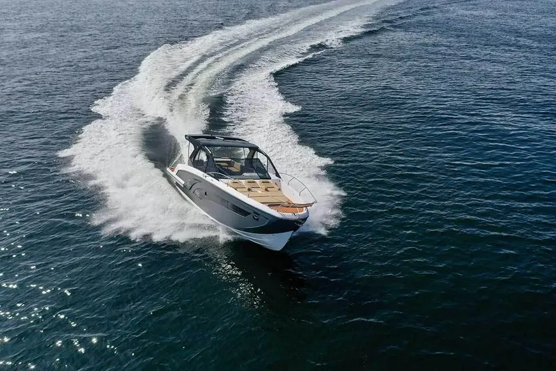 Slide: The Image of 2025 Hanover 387 Inboard boat cruising on open water, creating a dynamic wake. - 2