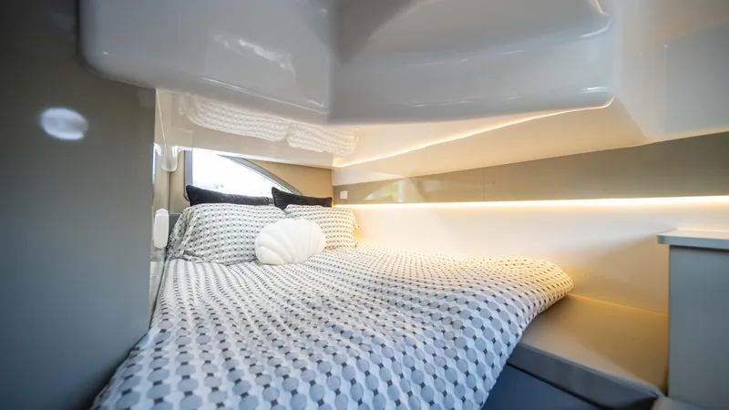 Slide: The Image of Cozy cabin interior of 2025 Hanover 387 Outboard with modern bedding and ambient lighting. - 26