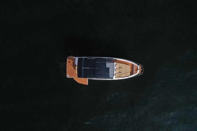 Slide: The Image of Aerial view of 2025 Hanover 387 Inboard boat on dark water. - 3