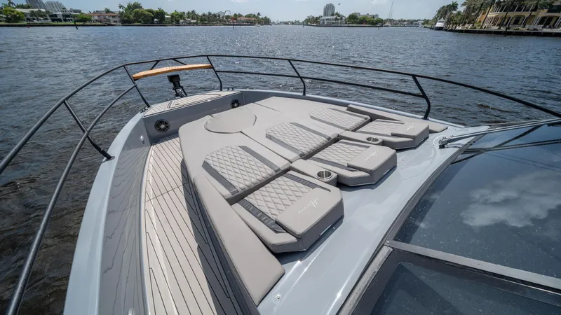Slide: The Image of 2025 Hanover 387 Outboard boat with spacious deck and luxurious seating on a scenic waterway. - 4