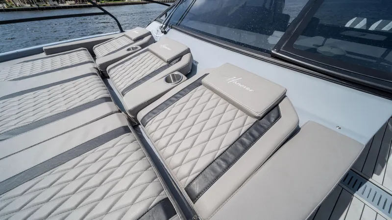 Slide: The Image of Luxurious seating on 2025 Hanover 387 Outboard boat with quilted design and cup holders. - 5