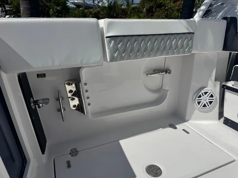 Slide: The Image of 2026 Blackfin 272 DC boat interior with sleek white seating and stainless steel fixtures. - 11