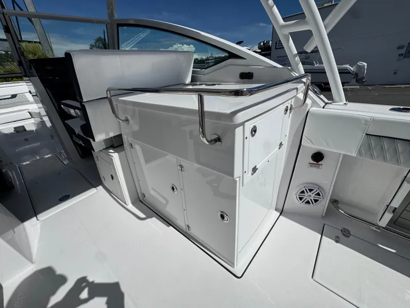Slide: The Image of 2026 Blackfin 272 DC boat interior with sleek white cabinetry and seating. - 17