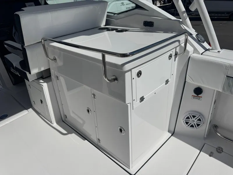 Slide: The Image of 2026 Blackfin 272 DC boat interior with sleek white cabinetry and seating. - 19