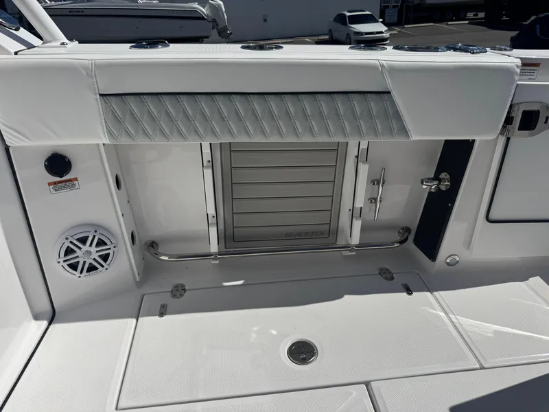 Slide: The Image of 2026 Blackfin 272 DC boat interior with storage compartment and speaker. - 20