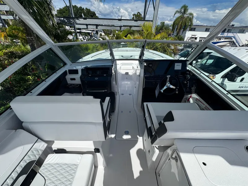 Slide: The Image of 2026 Blackfin 272 DC boat interior with white seating and modern dashboard. - 23